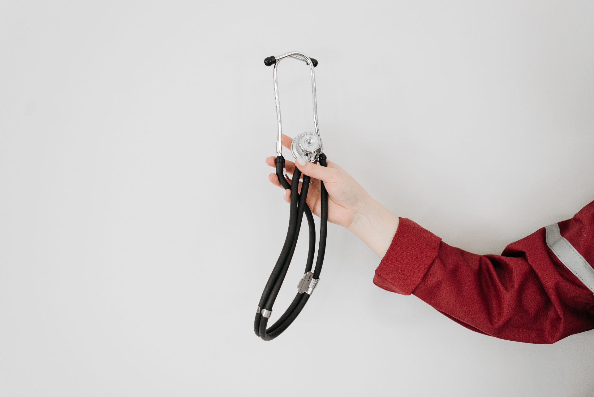 Clinician holding a stethoscope
